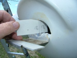 Here is the repair in place and the gauge measuring the opening.  I smeared a little caulk on to prevent toe nails hanging and the martins seem to like it, about 3 or 4 pair on this pole.